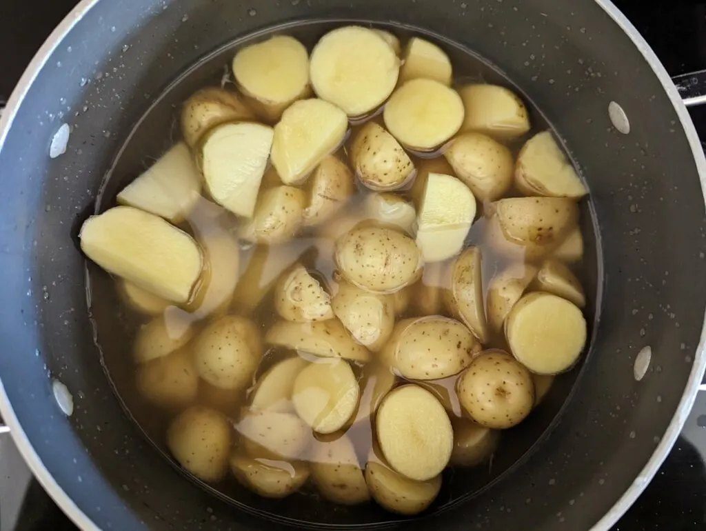 Potatoes boiling in a stockpot. 