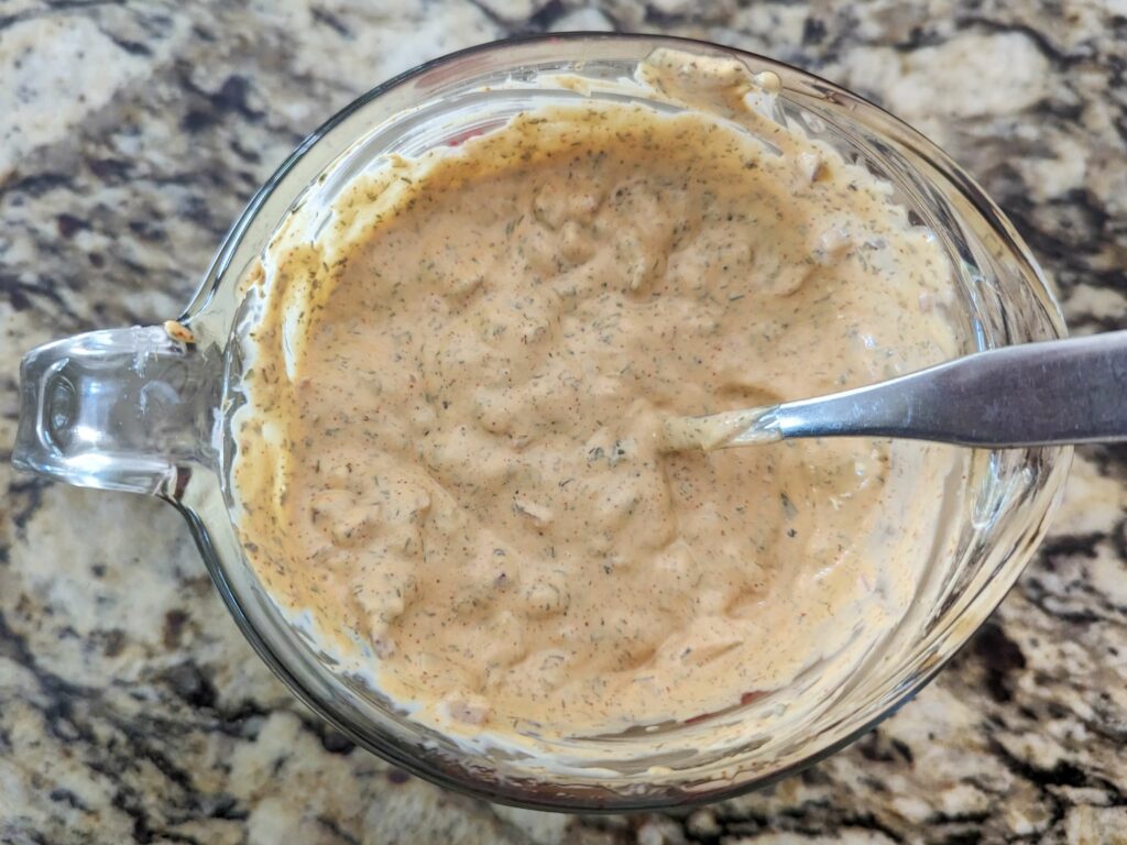 The potato salad dressing in a mixing bowl.