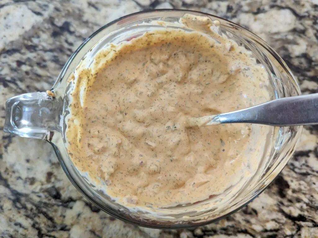 The potato salad dressing in a mixing bowl.