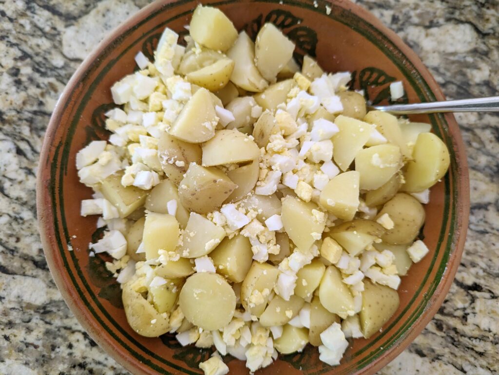 Stir the hard-boiled eggs into the potato salad.