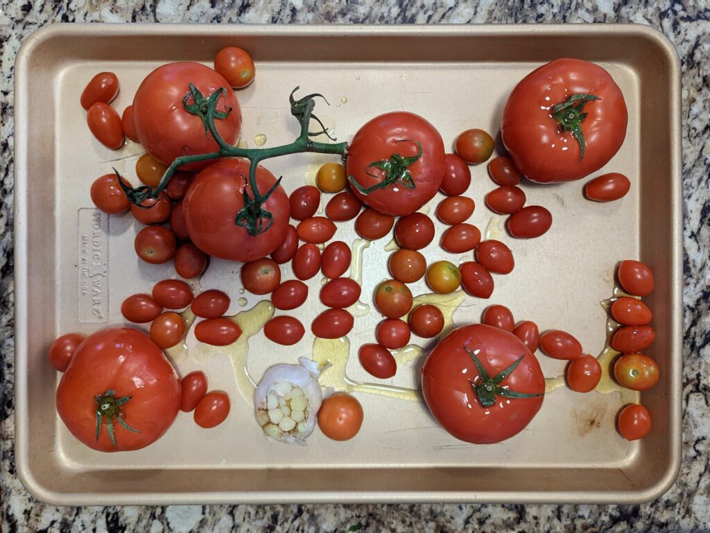 Line the tomatoes onto a rimmed baking sheet and drizzle with olive oil.