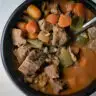 Dutch oven beef and barley soup in a bowl.