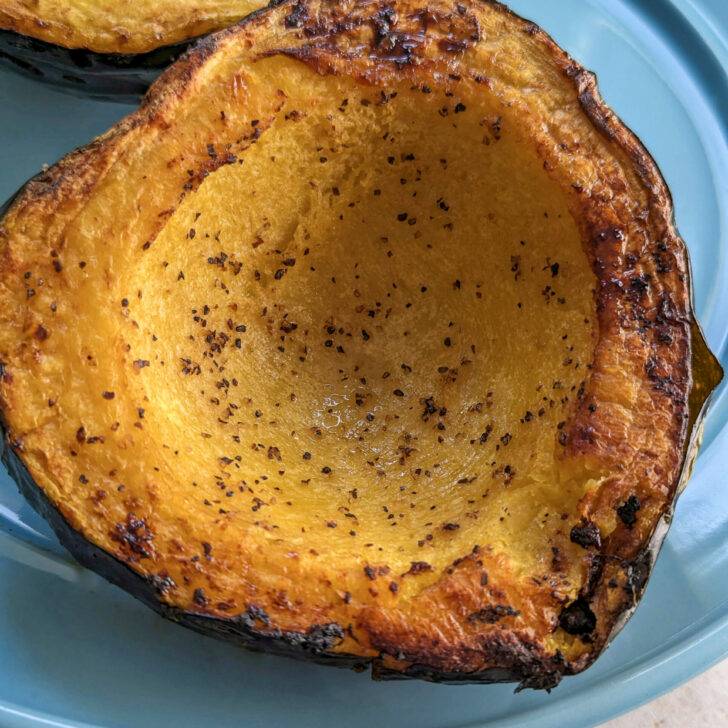 Cooked acorn squash on a plate.