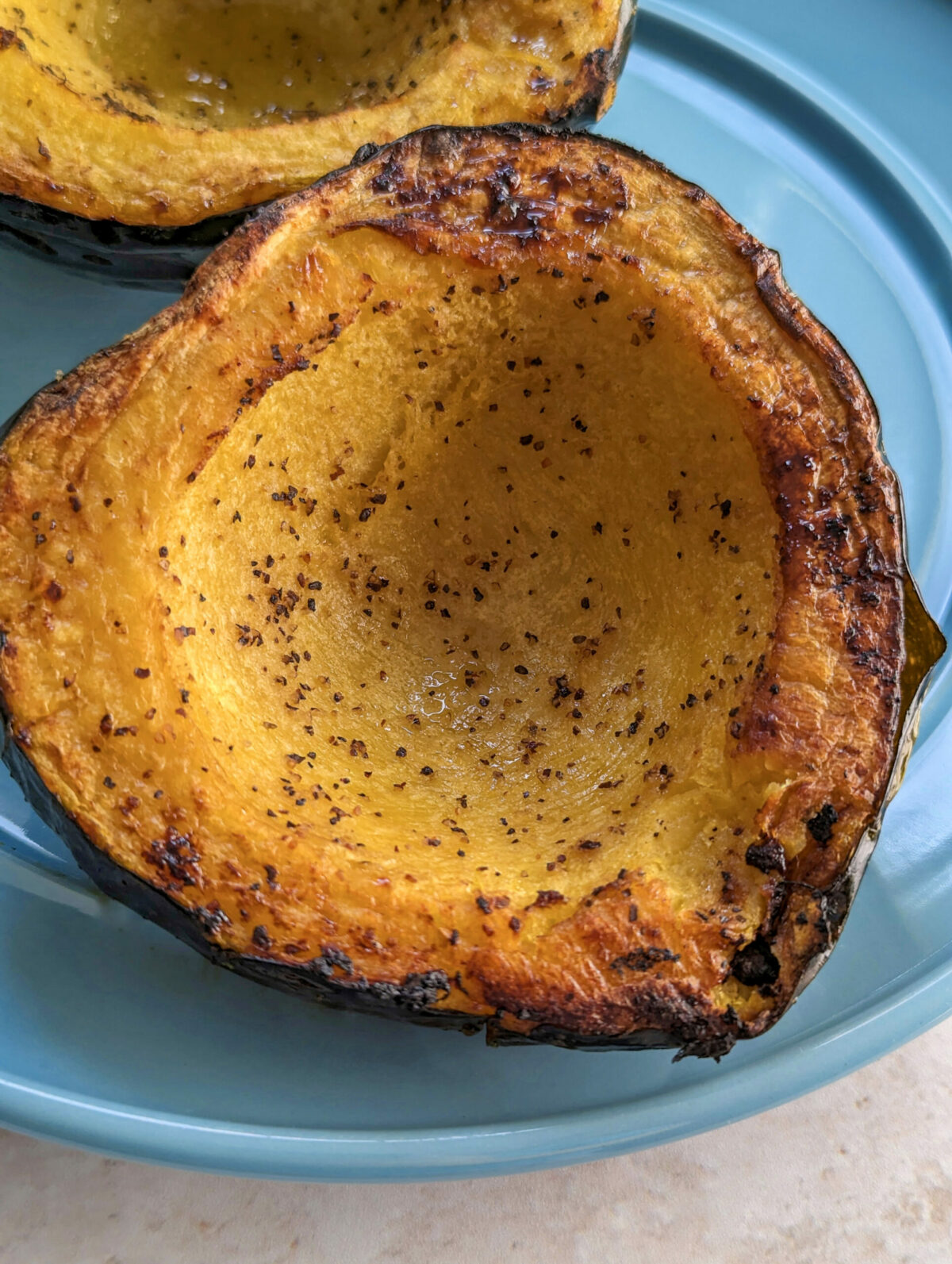 Cooked acorn squash on a plate.