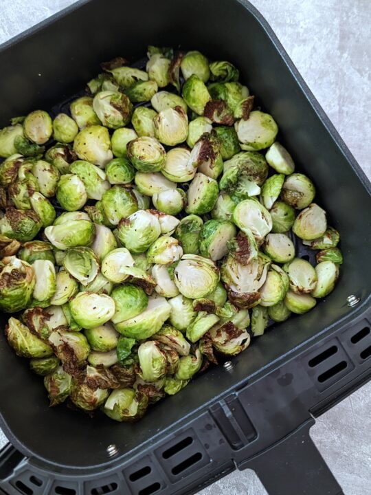 Crispy brussel sprouts in the air fryer basket.