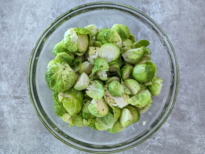 Toss the Brussel sprouts with oil, salt, and pepper in a large mixing bowl.
