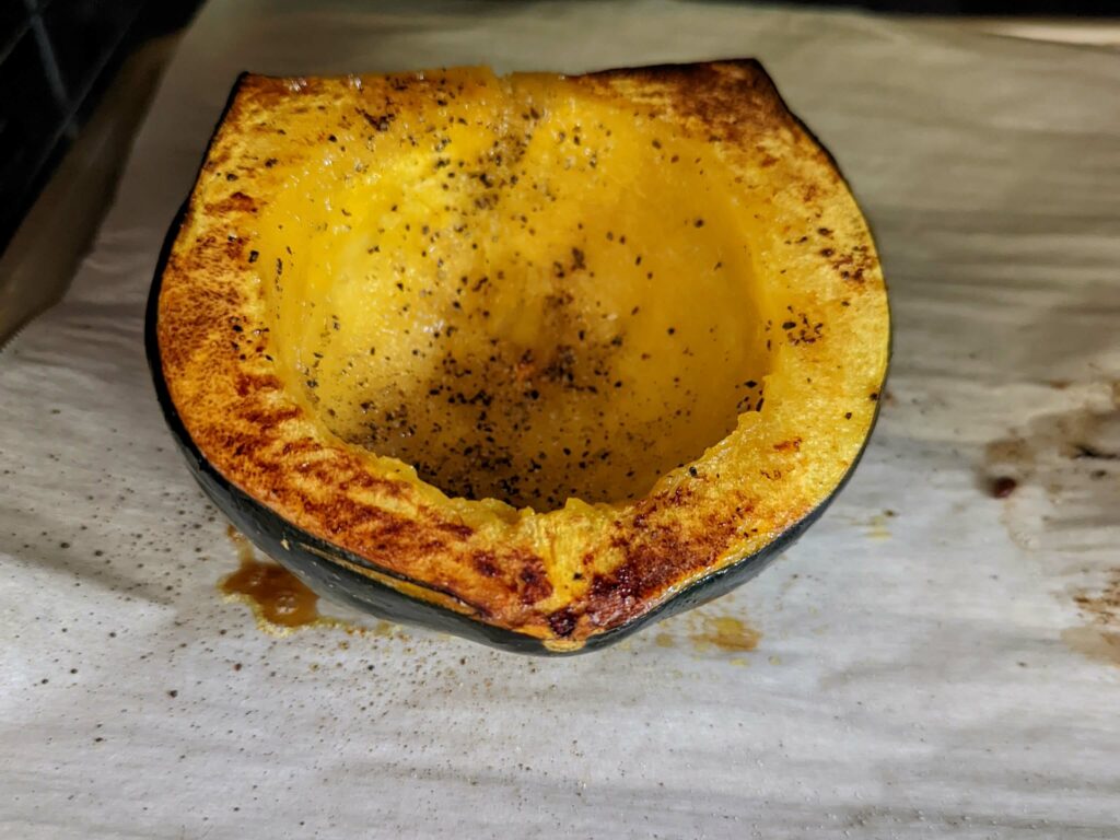 A baked acorn squash in the oven.