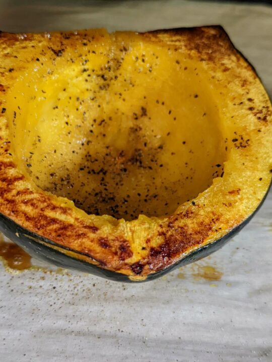 A baked acorn squash in the oven.
