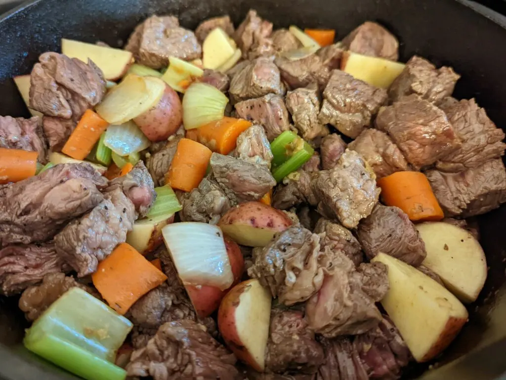 Add the broth, beef and vegetables and pressure cook.