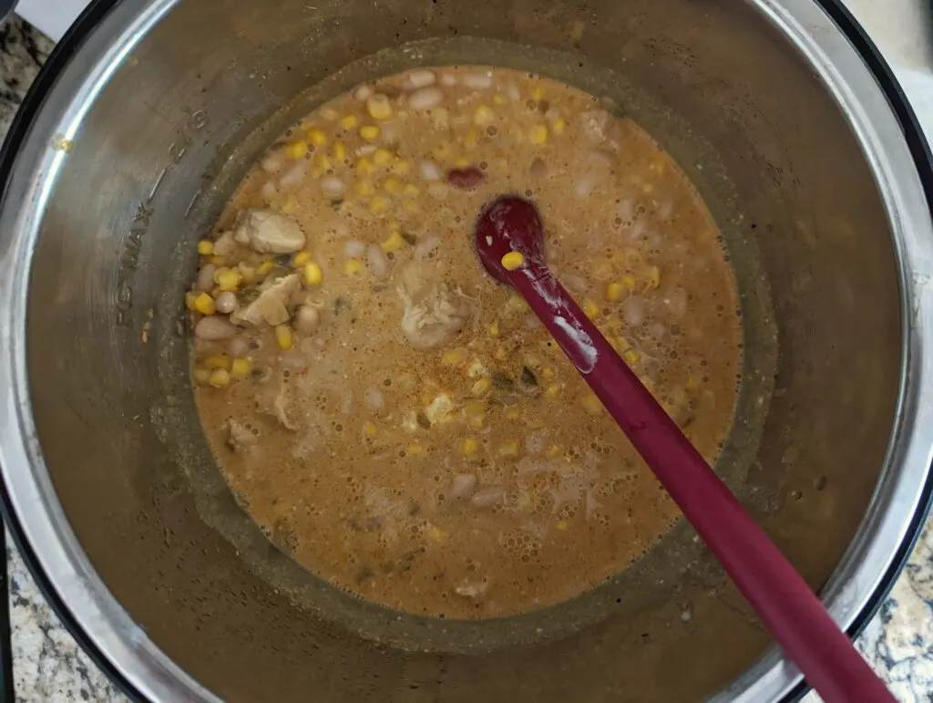 Beans and corn stirred into the white chicken chili.