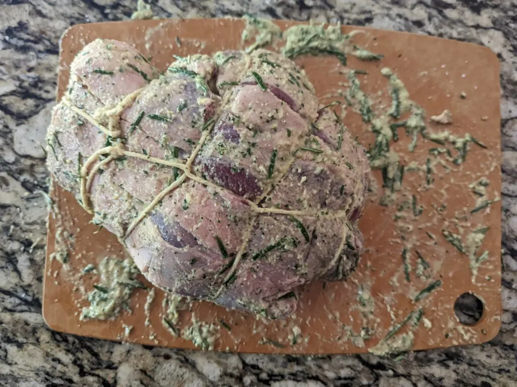 Boneless leg of lamb rolled up and secured with cooking twine.