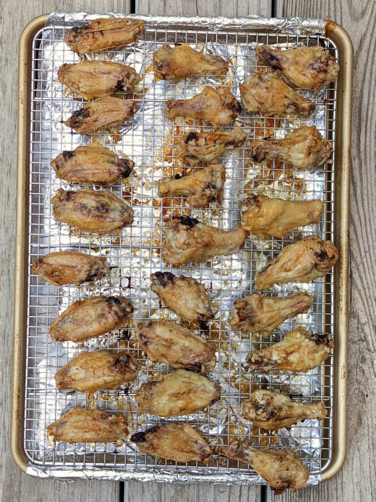A baking sheet of cooked crispy wings.