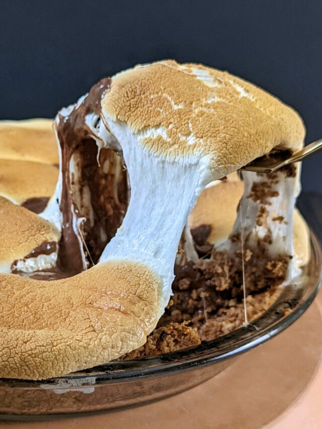 A slice of smores pie being scooped out of the pie dish.