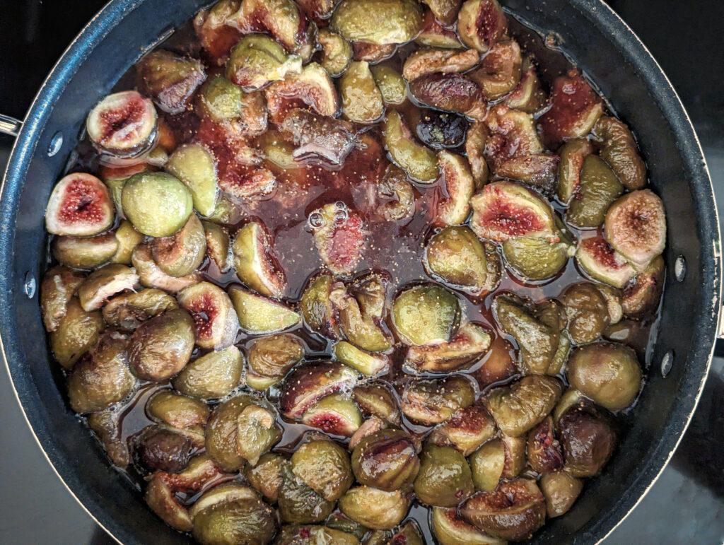 Figs warming in a saute pan.