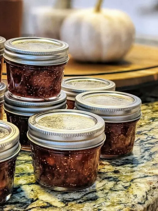 Our fig jam recipe divided in jars stacked on the counter.