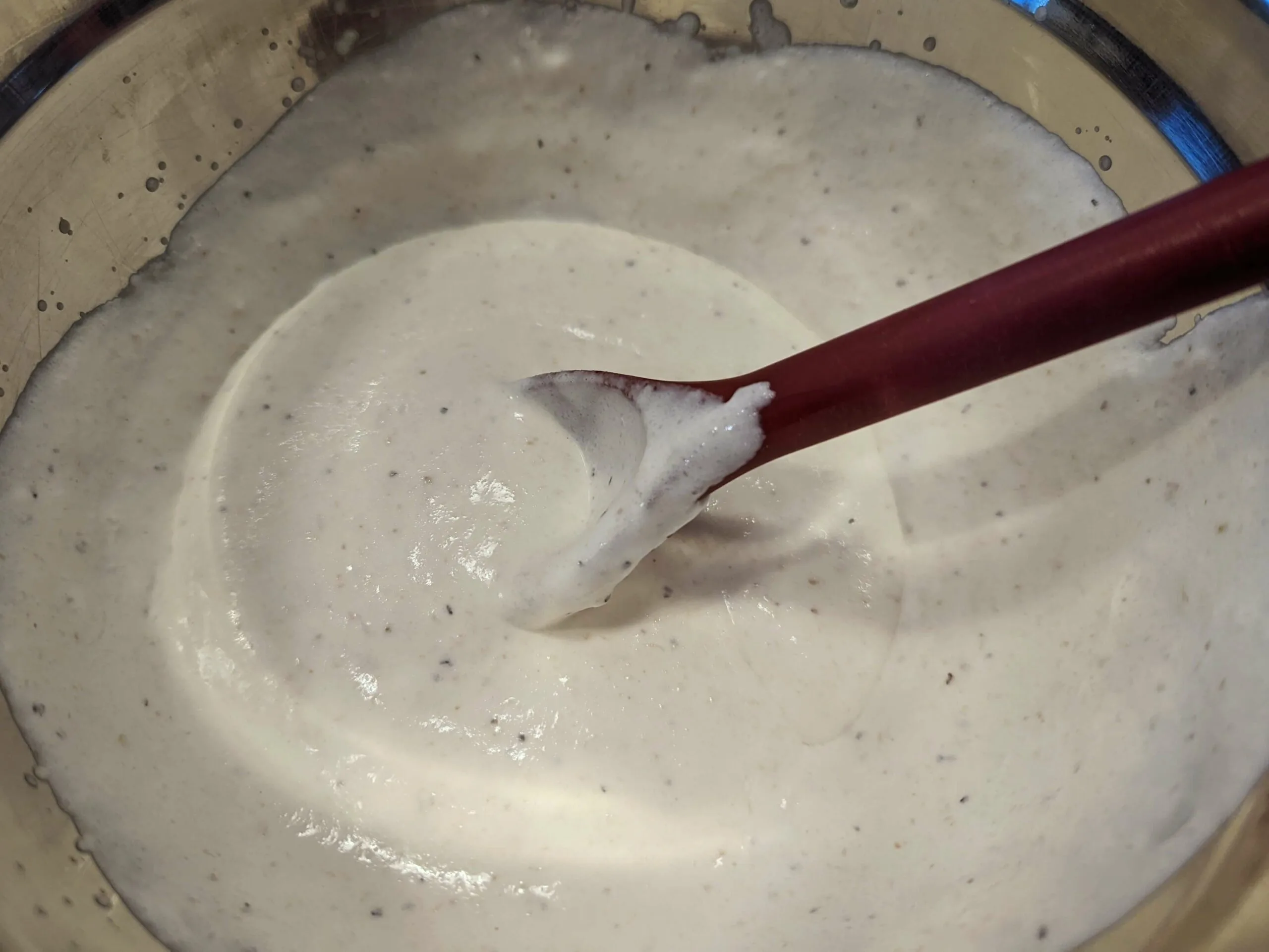 Stirring the ingredients for horseradish cream sauce in a large mixing bowl. 