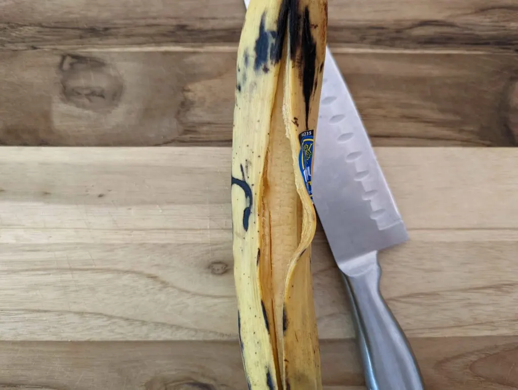 The peel of a plantain cut lengthwise with a knife.