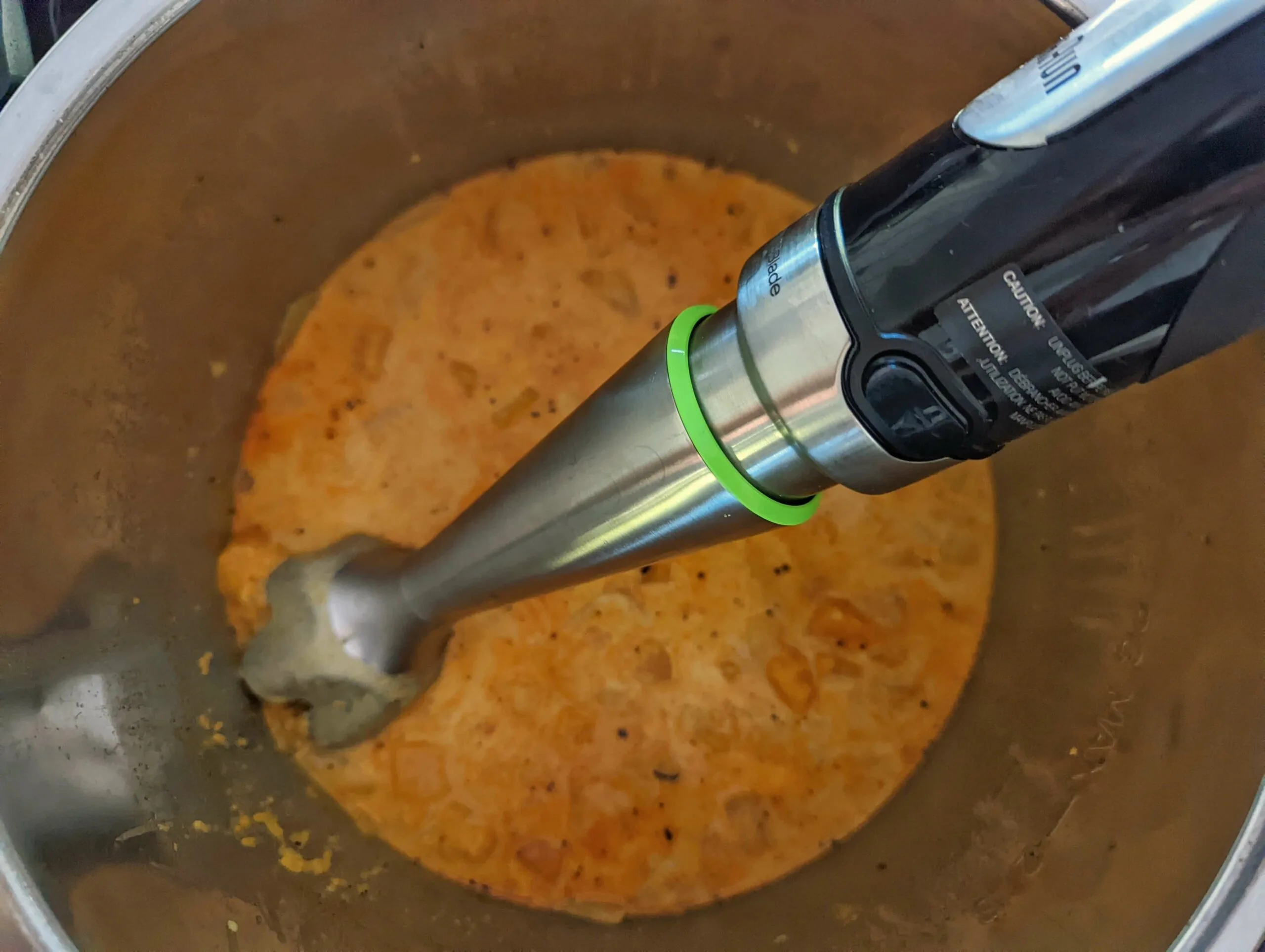 Pureeing the soup inside of the Instant Pot with an Immersion blender.