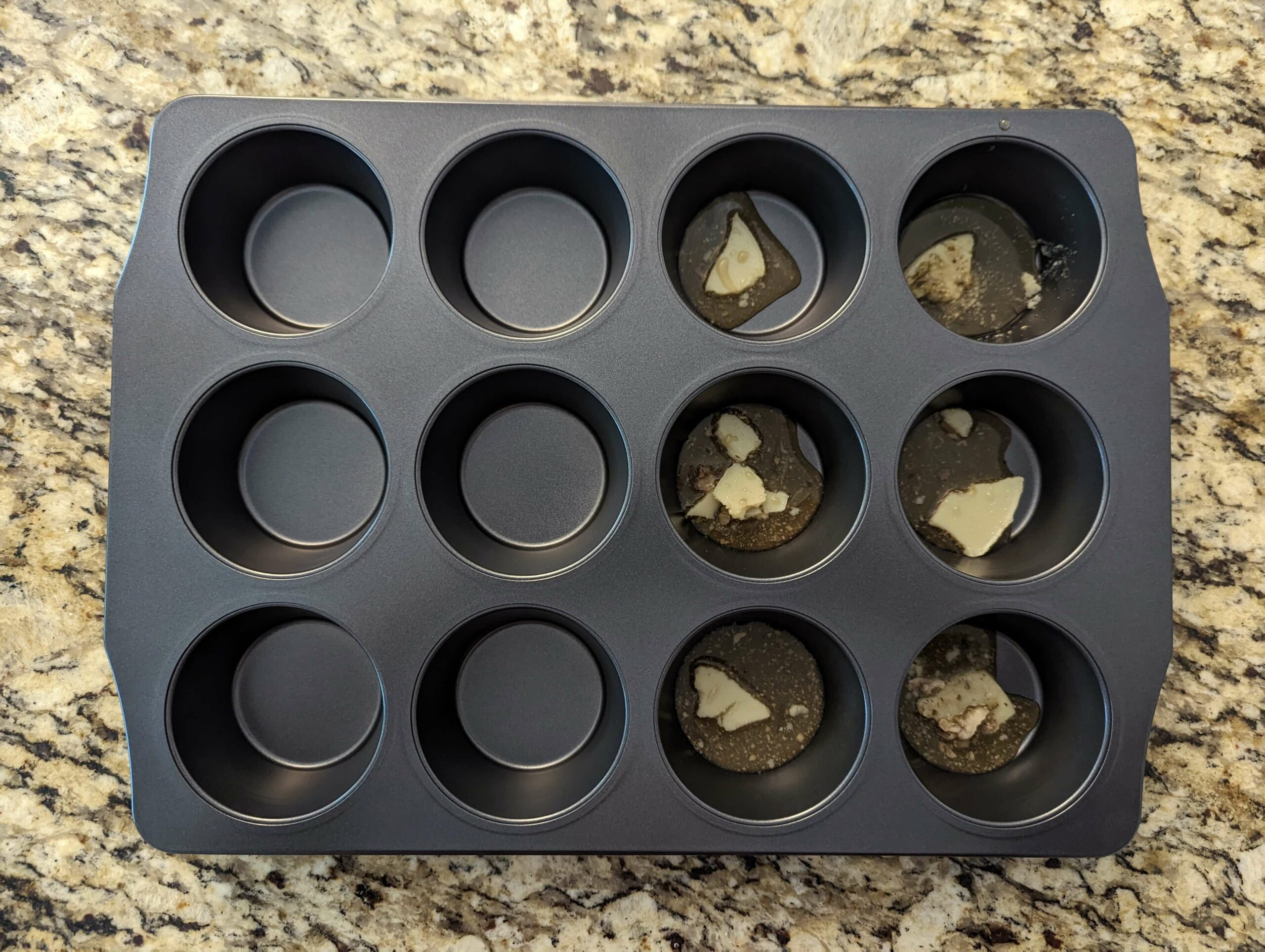 Beef drippings in a muffin tin.