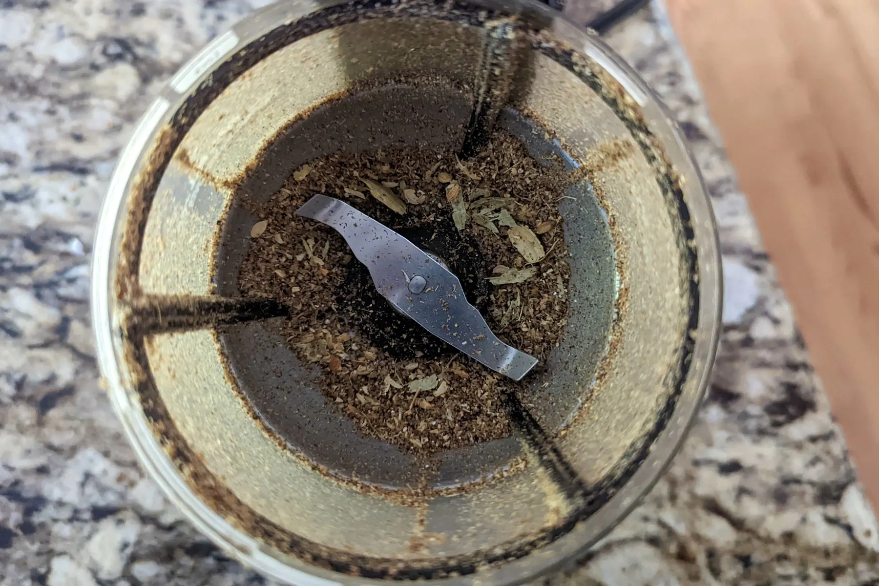 Whole spices in a spice grinder.