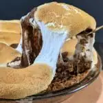 A slice of easy smores pie being scooped out of the pie dish.