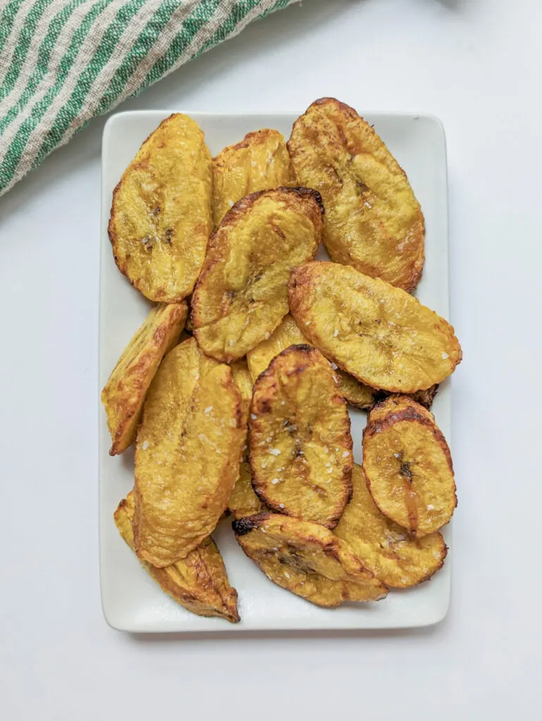 Air fried plantains on a plate.