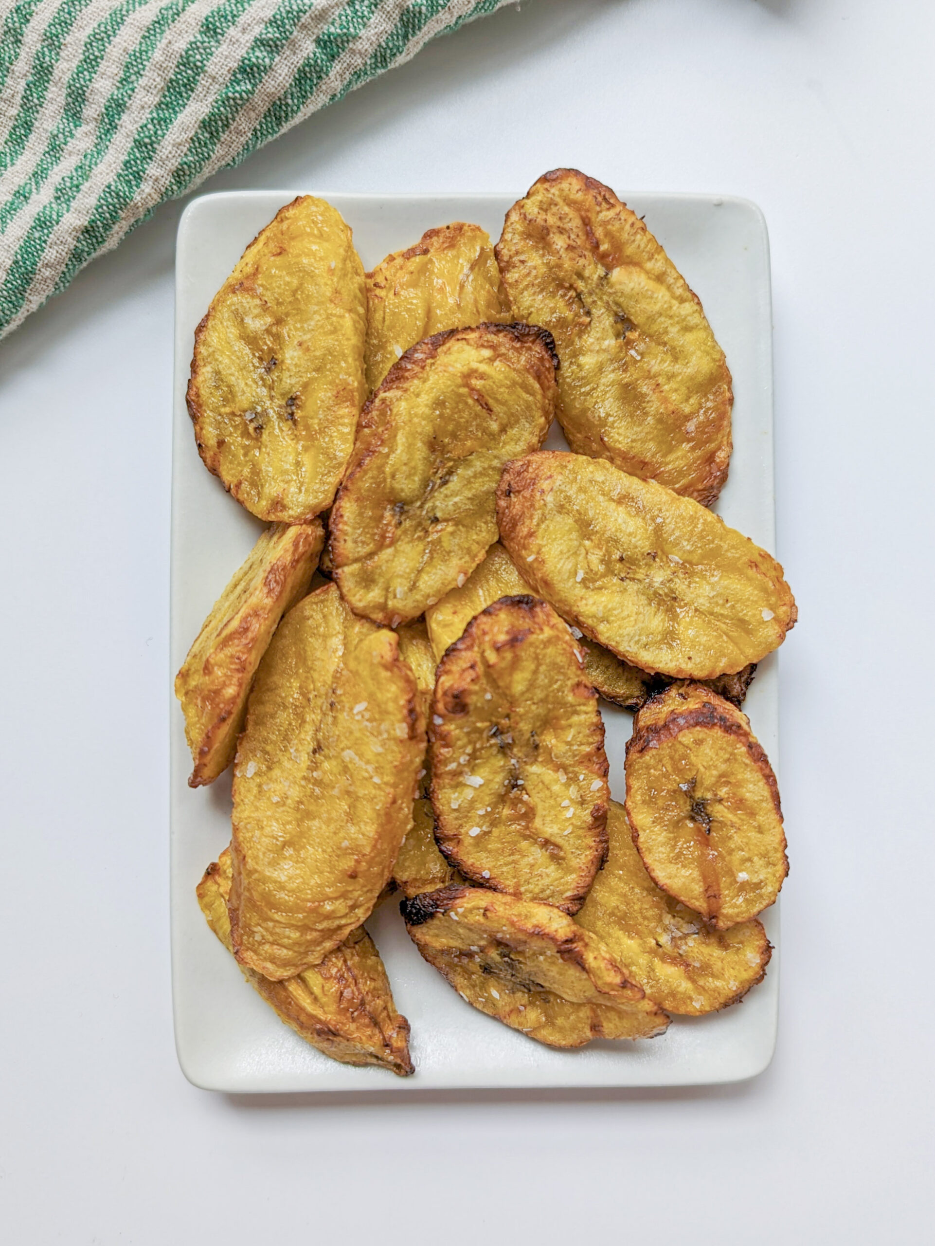 Air fried plantains on a serving plate.