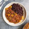Beef picadillo on a plate with beans.