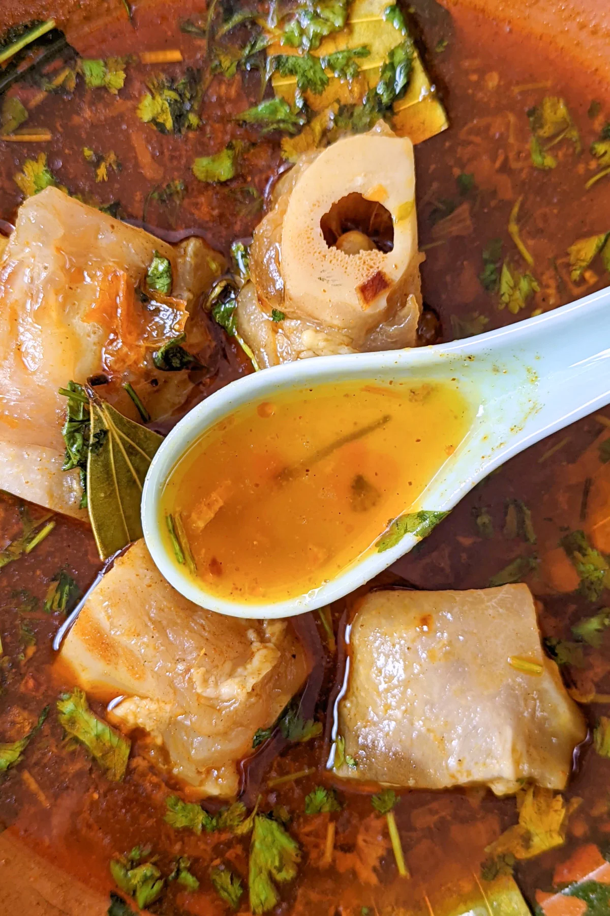 Paya soup in a bowl.