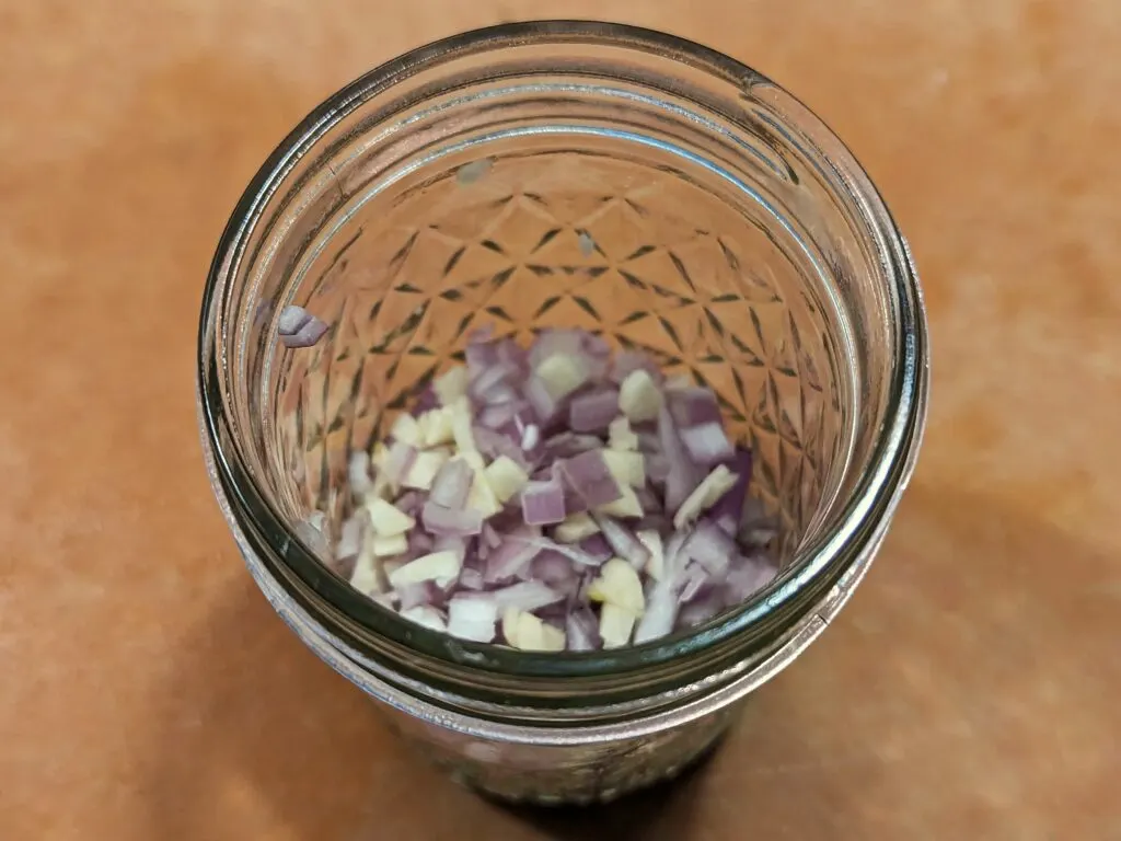 Shallots and the bottom of a glass container.