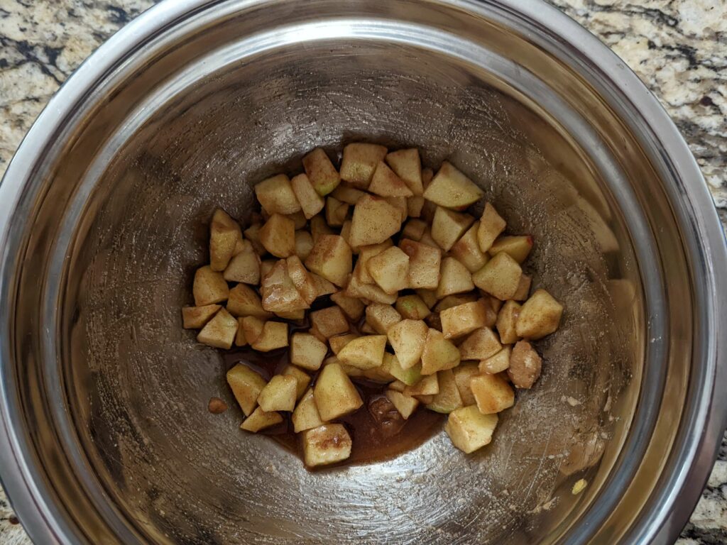 Combine apples with brown sugar, lemon, cinnamon, and nutmeg.