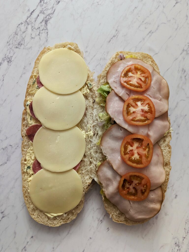 Cheese and tomato added to the sandwich.