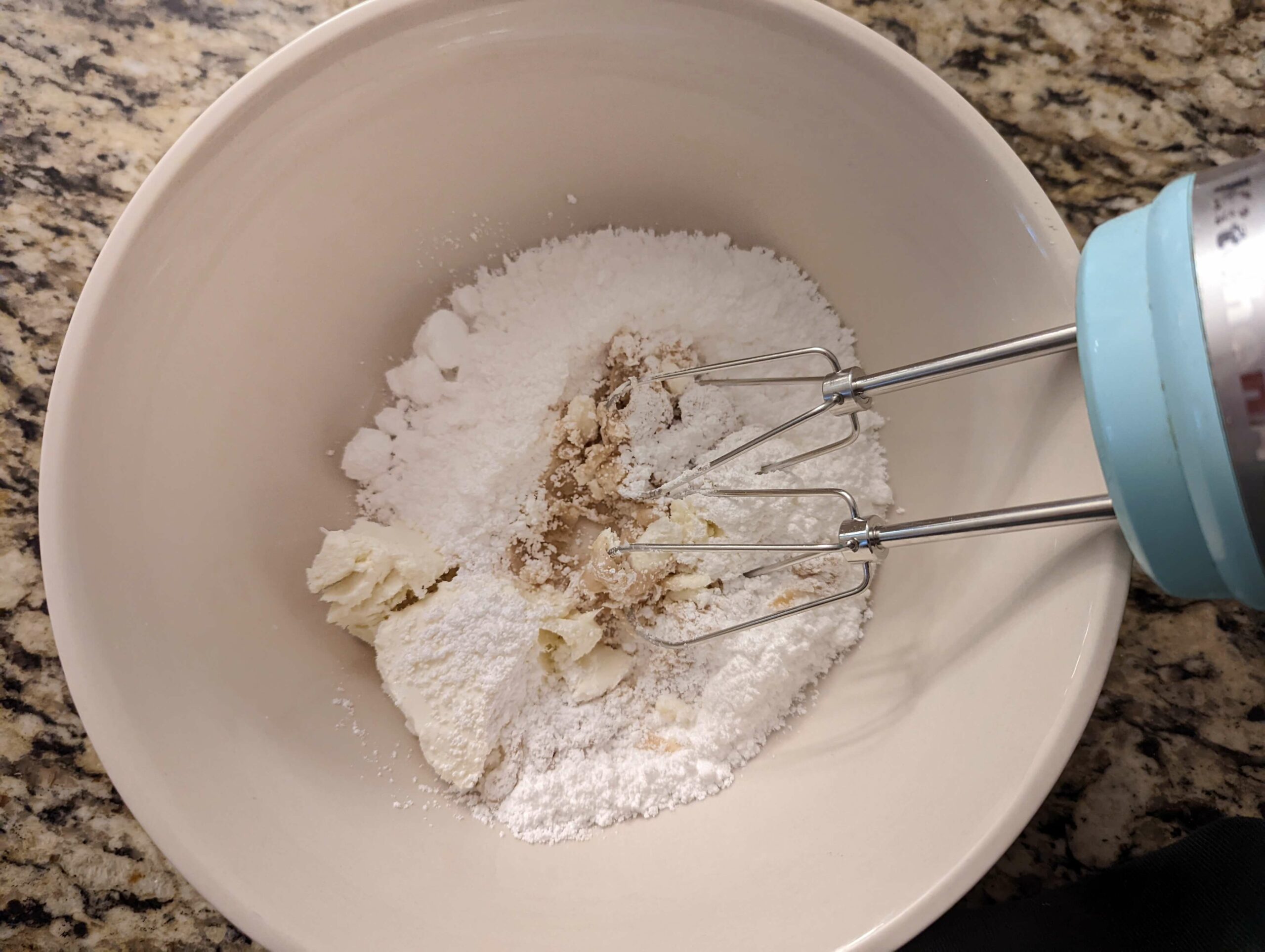 Combine the ingredients for cream cheese frosting in a mixing bowl.