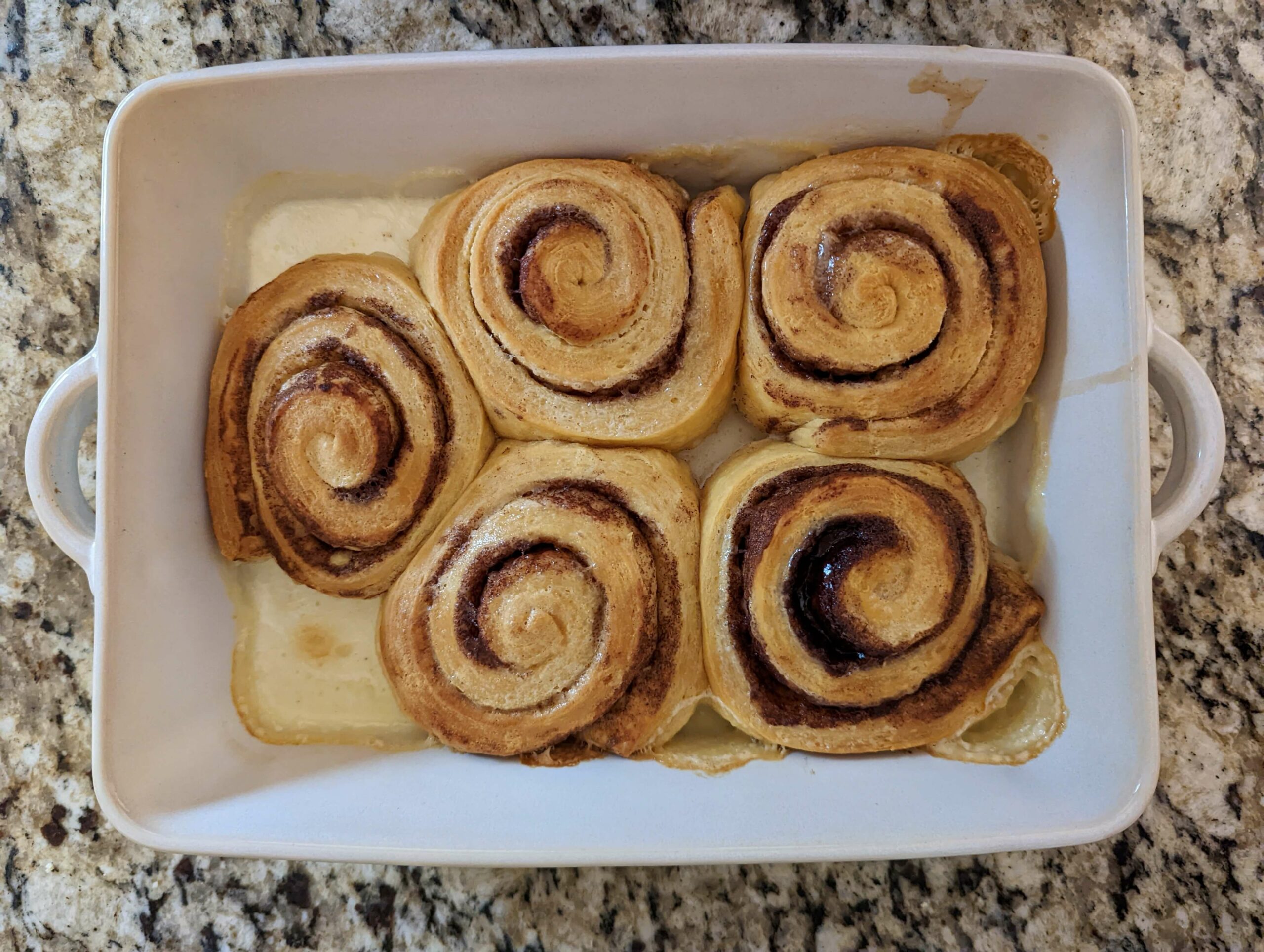 Cinnamon rolls baked in a baking pan.