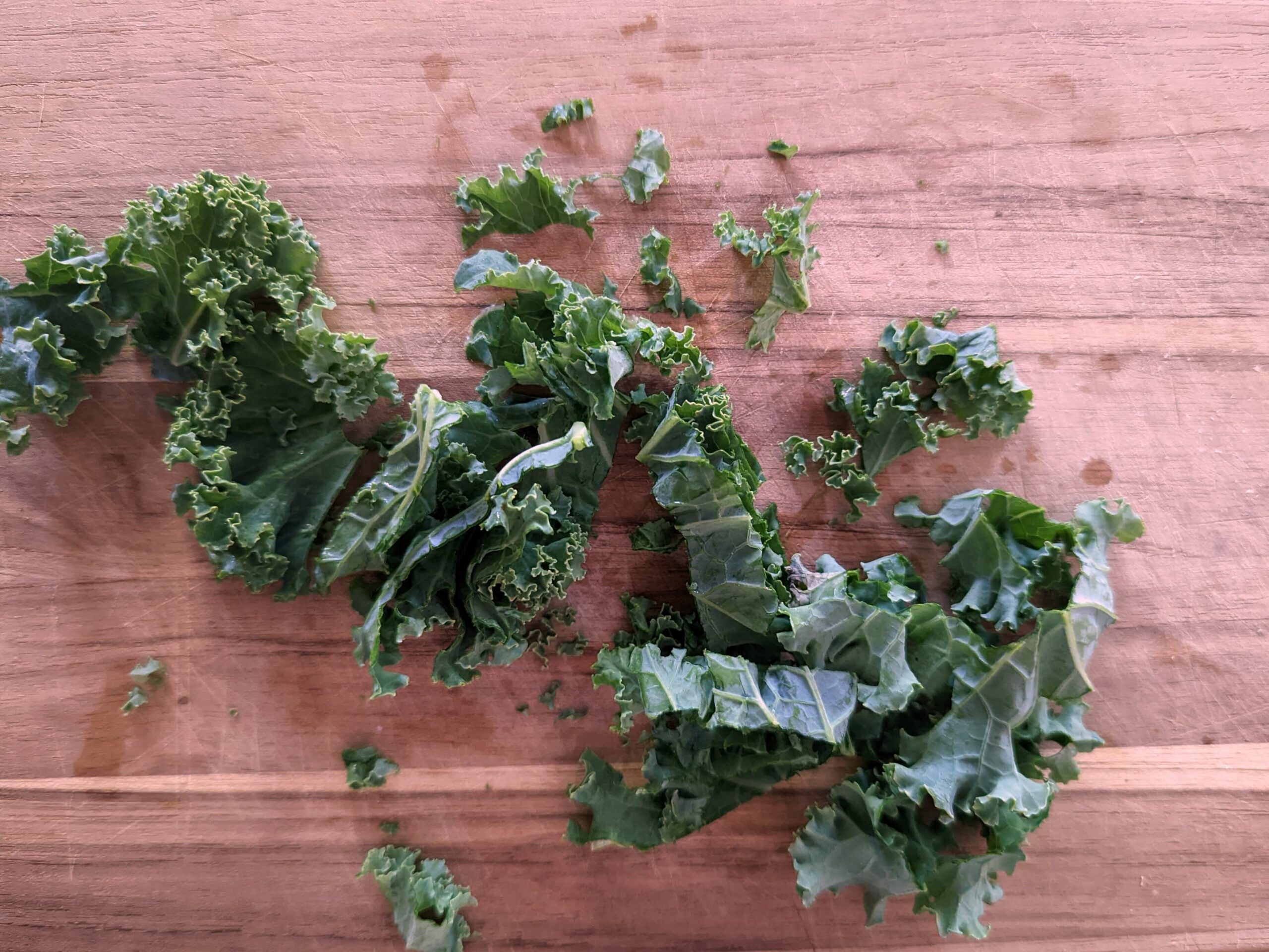 Kale being sliced into strips.