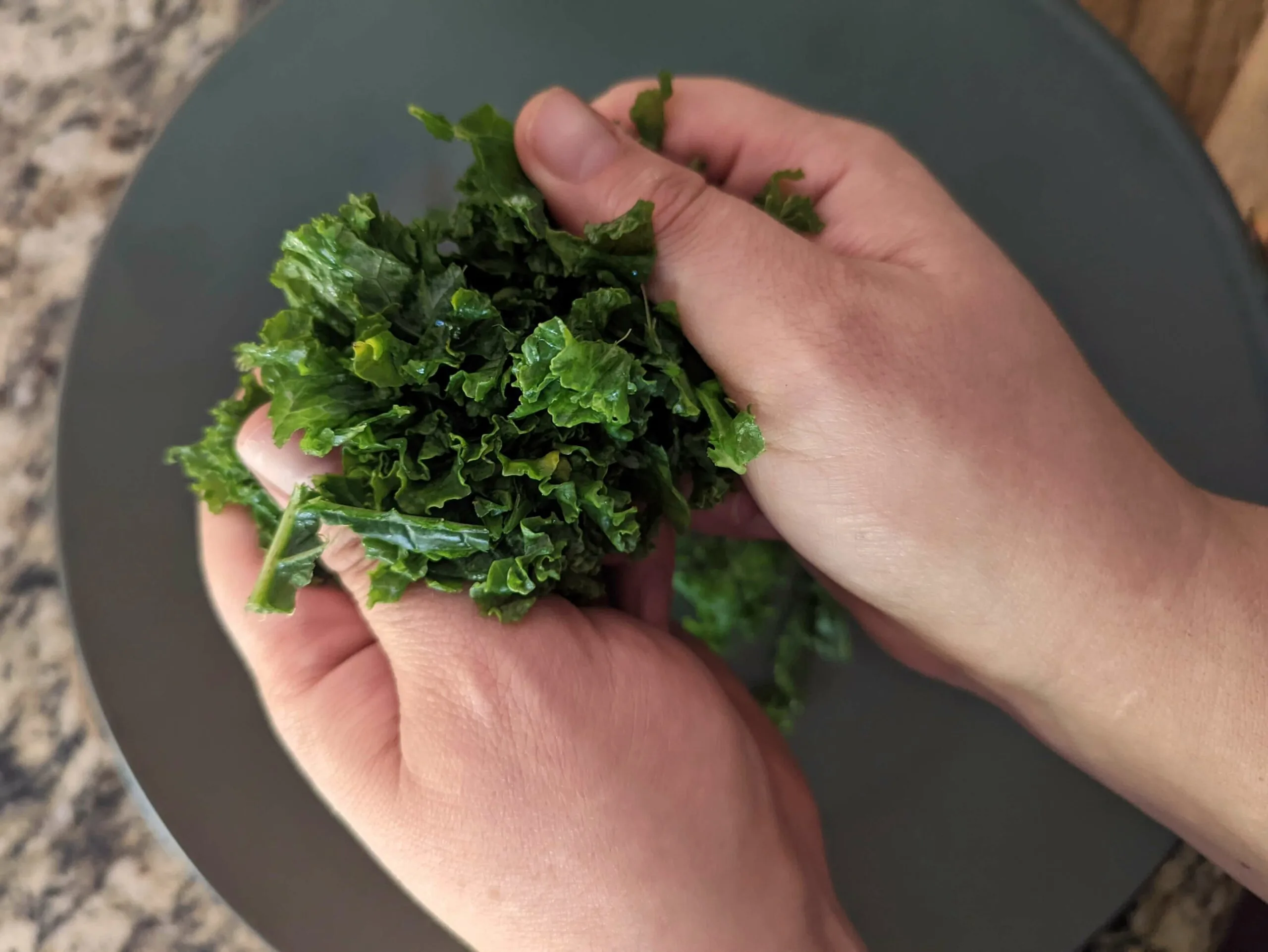 Kale being massaged for the kale salad.