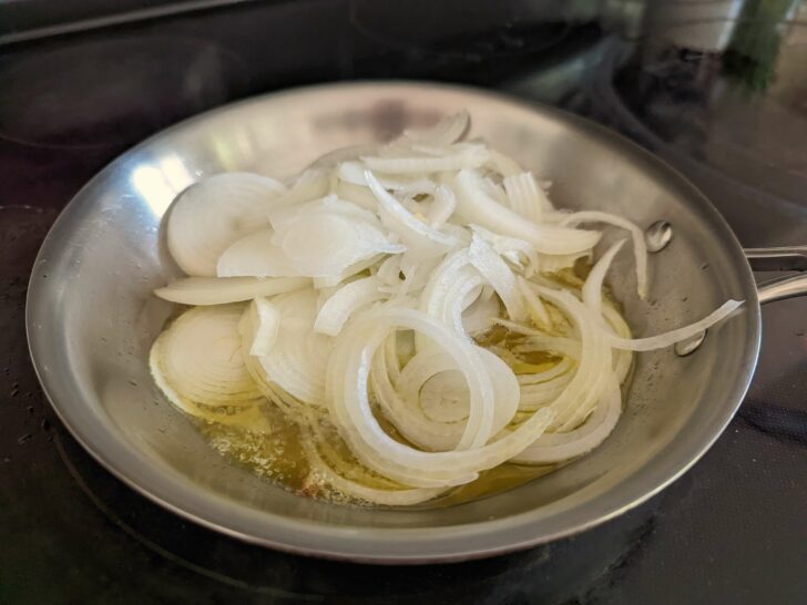 Onions frying in a small skillet.