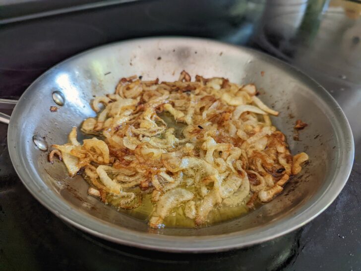 Golden brown onions in a small skillet.