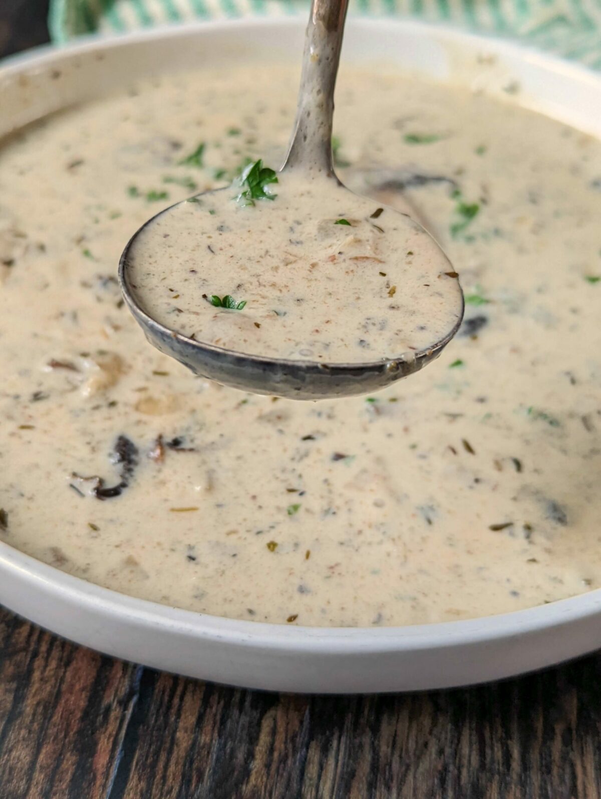 Keto cream of mushroom soup in a bowl with parsley.