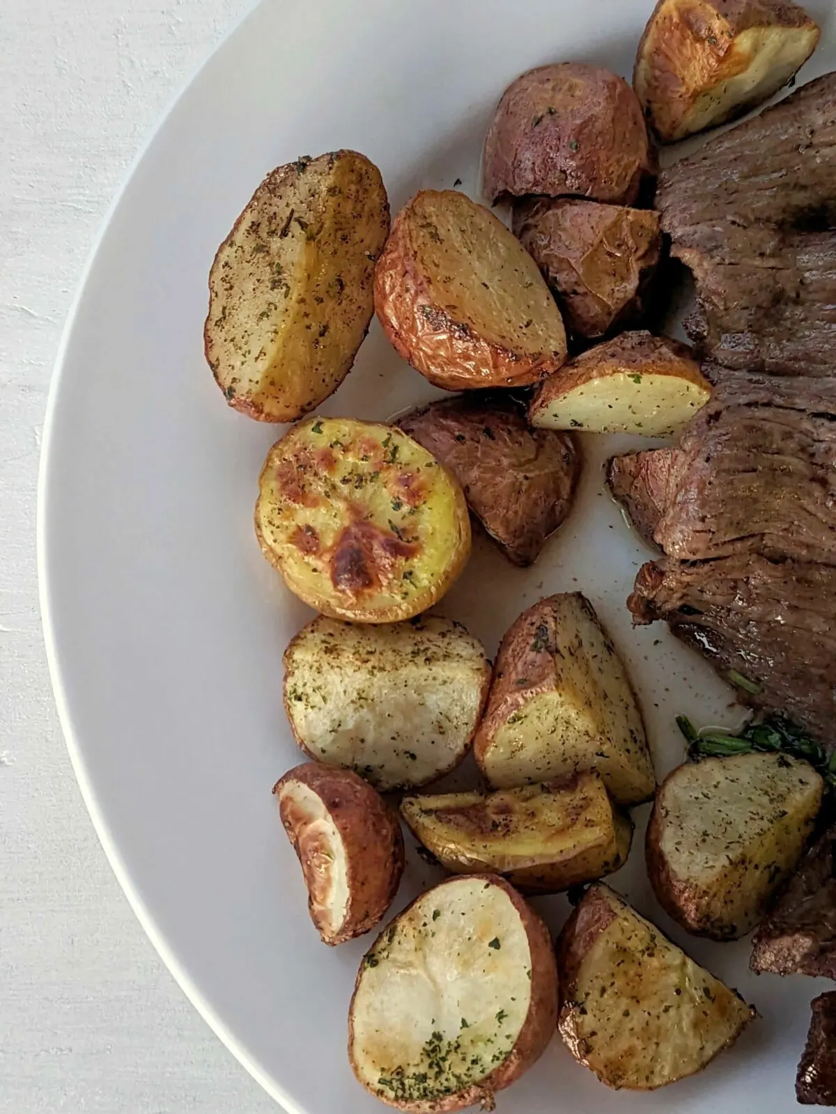 Roasted potatoes on a serving plate.