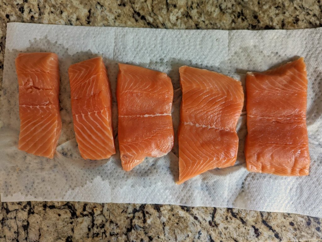 Salmon fillets drying on the counter.