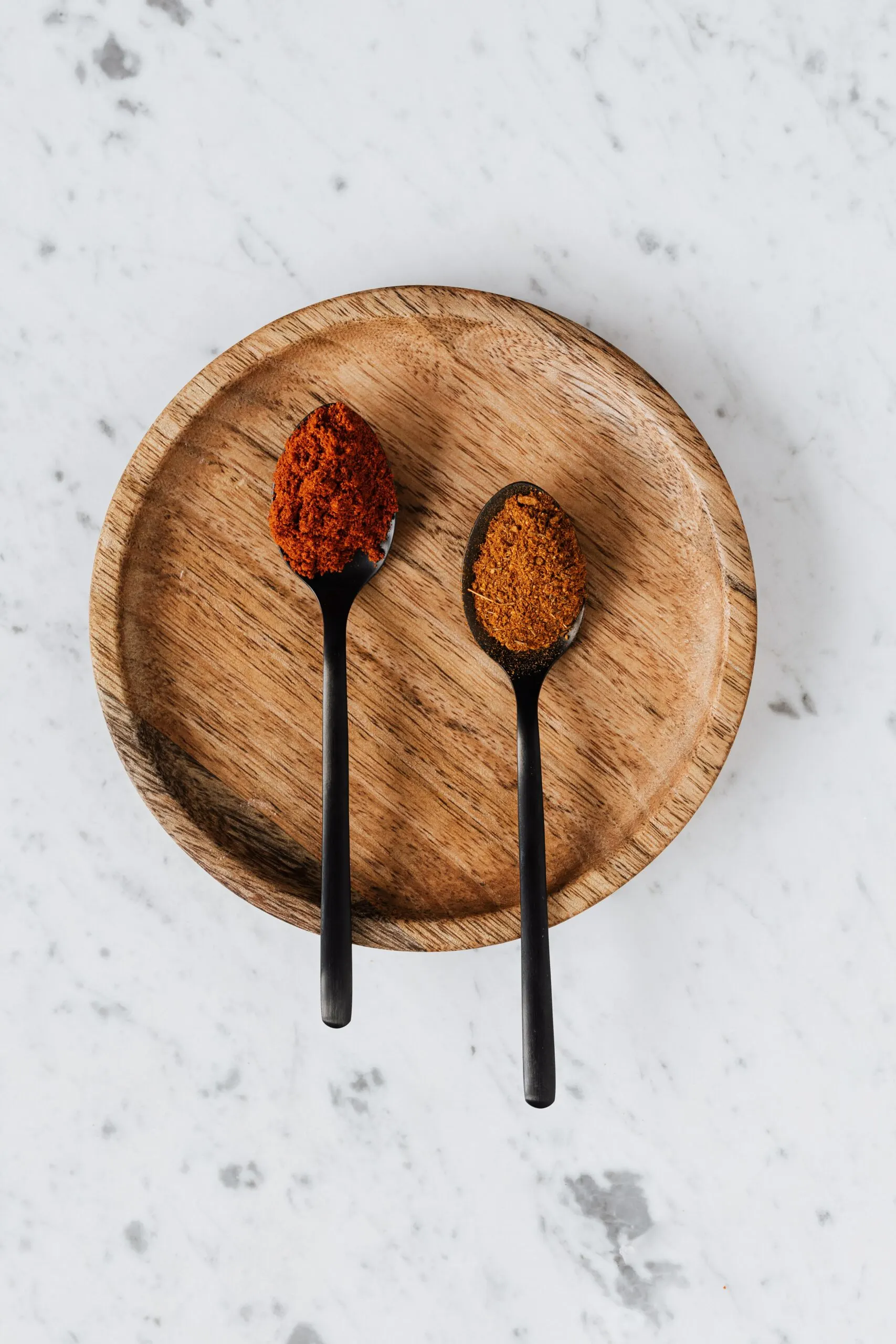 Two kinds of paprika on two spoons.