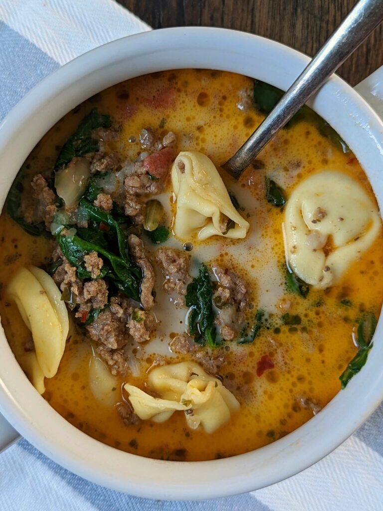 Instant Pot Tortellini soup in a soup bowl. 