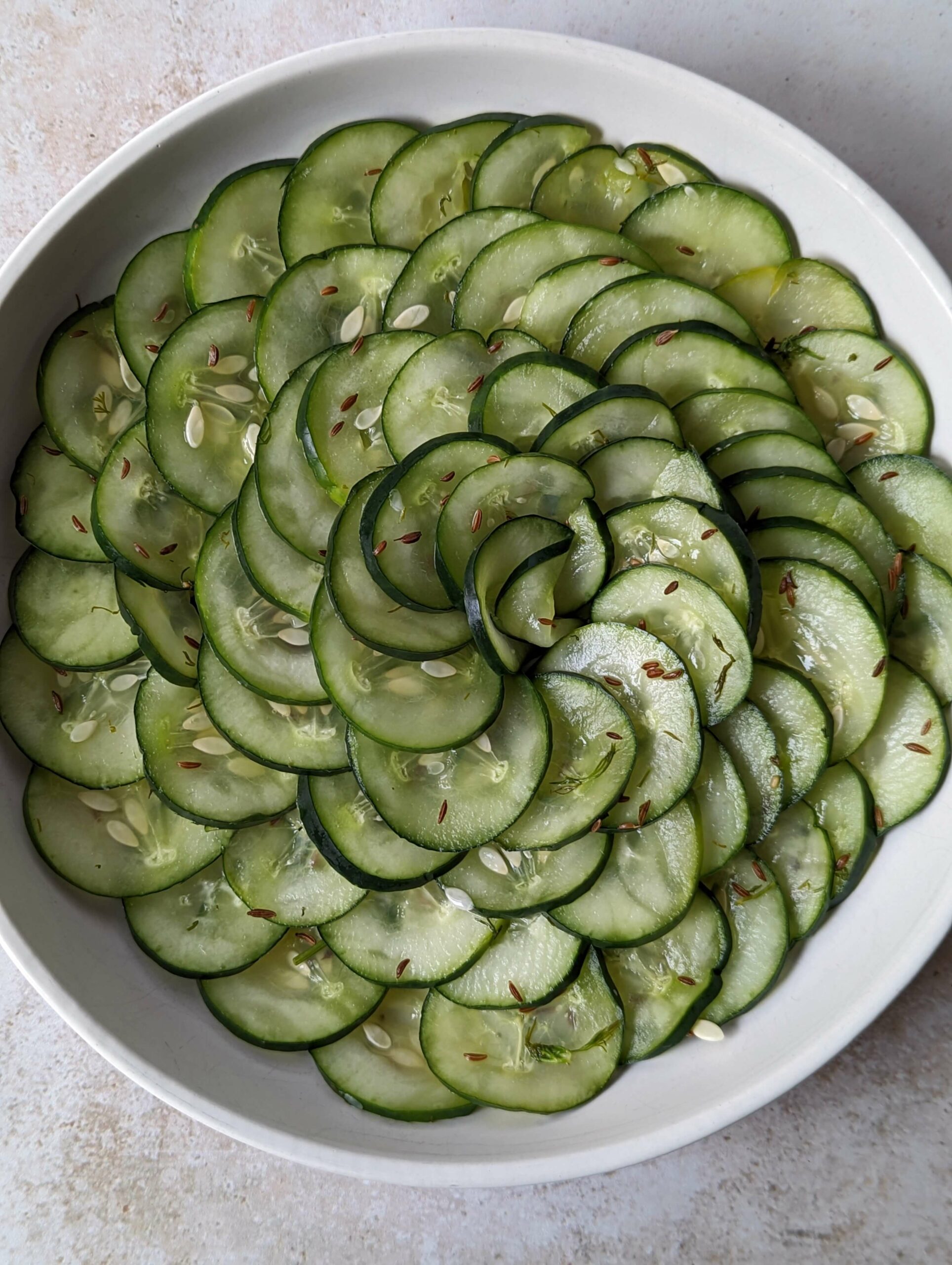 Pressgurka arranged in a swirl on a plate.