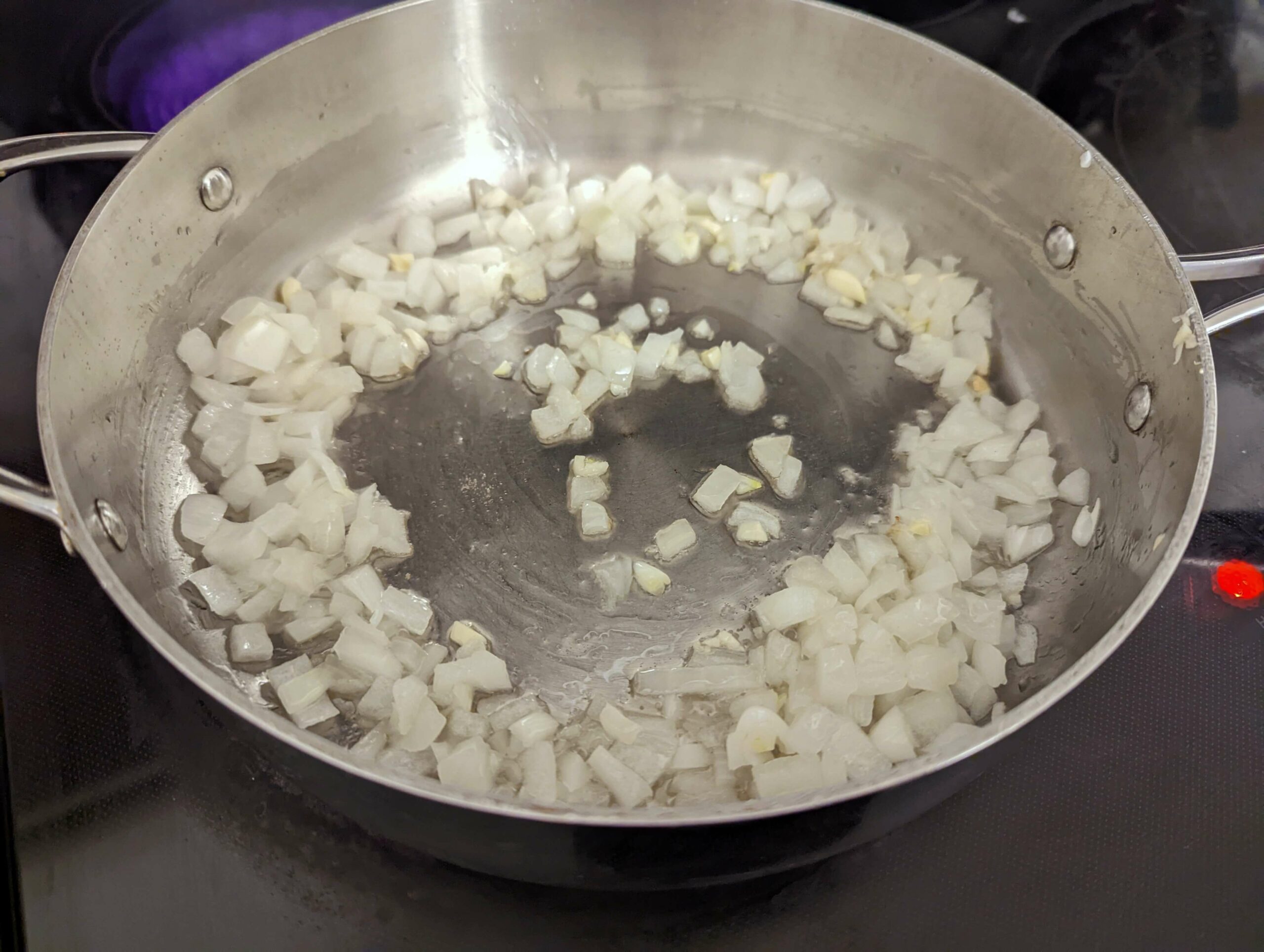 Onions cooking in a saute pan.
