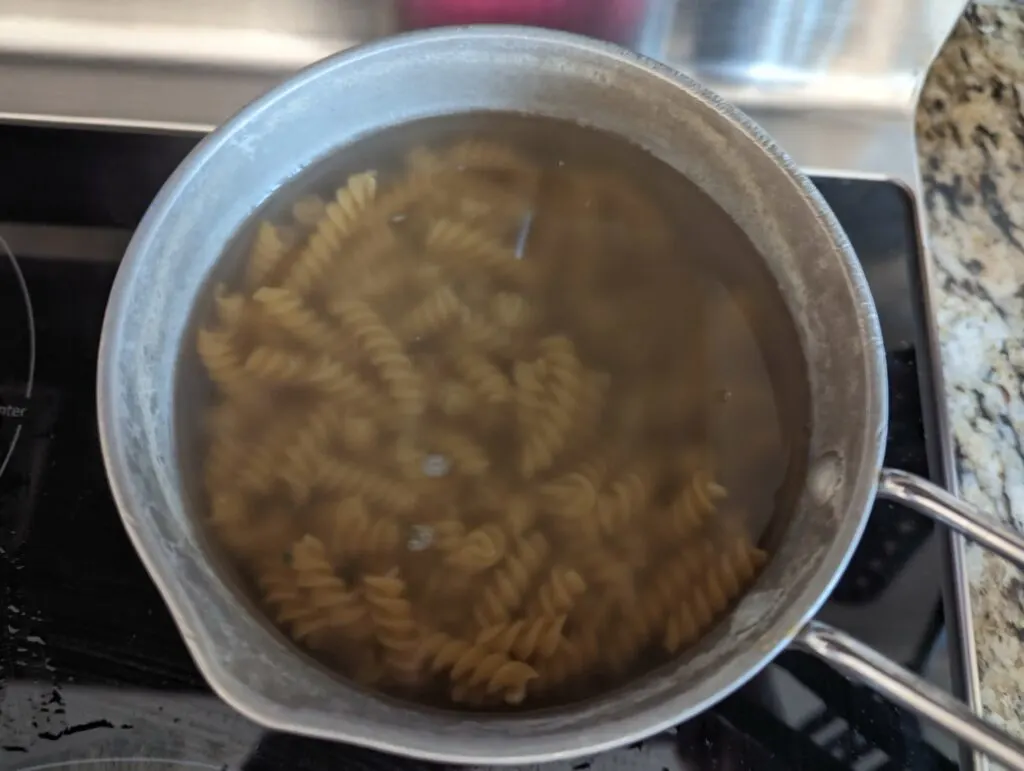 Noodles boiling in a sauce pan.