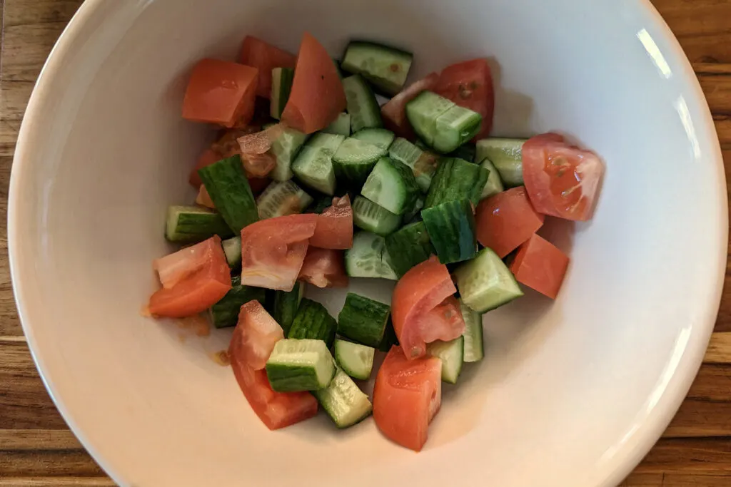 Cucumber and tomatoes in a bowl.