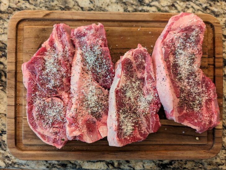 Chops generously seasoned with salt and pepper.