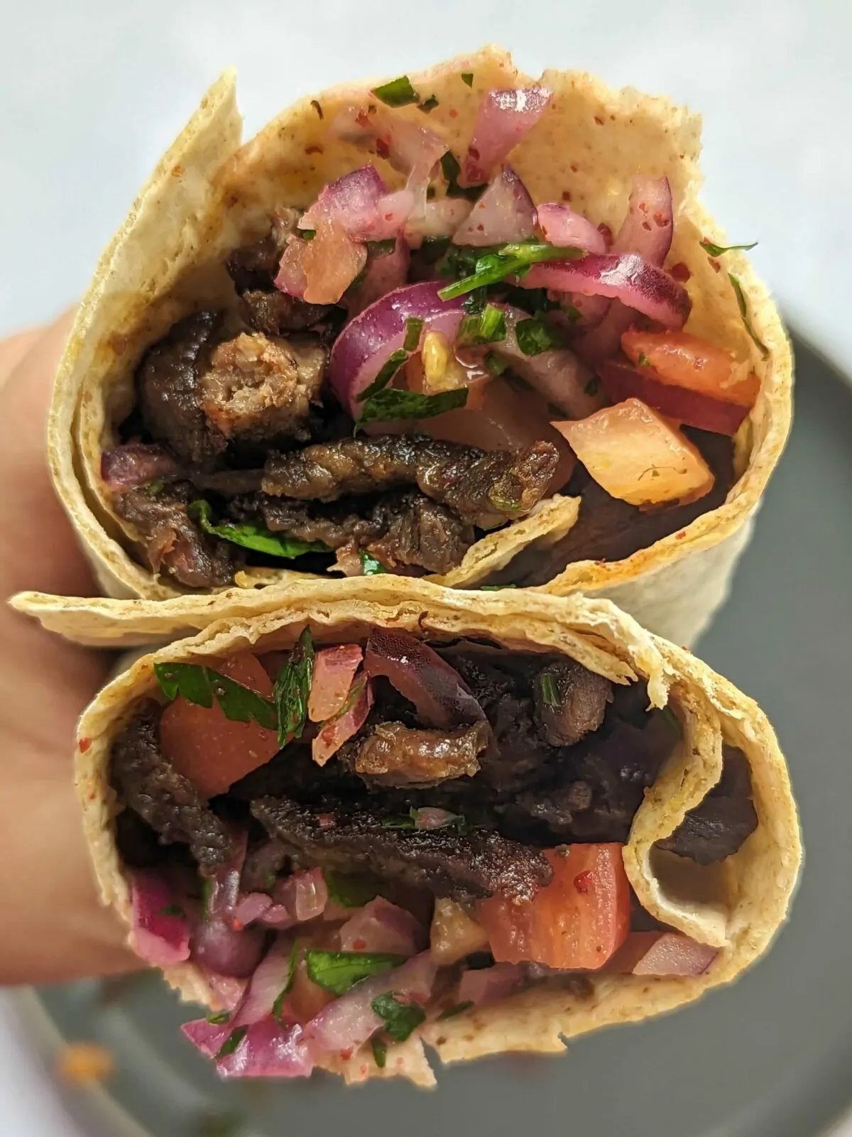 Over the top view of the cut-section of a tantuni wrap.