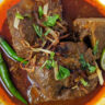 Nihari on a plate with naan.